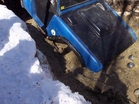 1974 Ford Bronco - Off-road vehicle stuck in mud and snow during an outing.