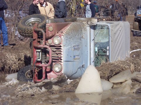 1974 Ford Bronco - This Jeep CJ rolled over in the mud and ice, with 'MUD SHARK' visible on its side.