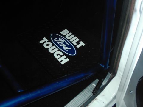 1978 Ford Bronco - A Ford floor mat with the 'Built Tough' slogan is visible inside a vehicle.