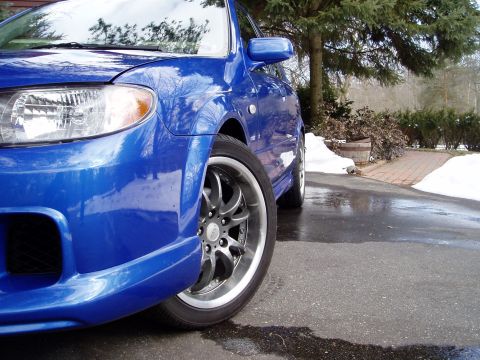 2003 Mazda Protege - Front corner view of a blue 2003 Mazda Protege during winter conditions.