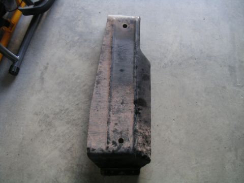 1994 Ford Bronco - A metal component, possibly a skid plate or bracket, rests on a concrete surface, marked with a Supermotors.net watermark.