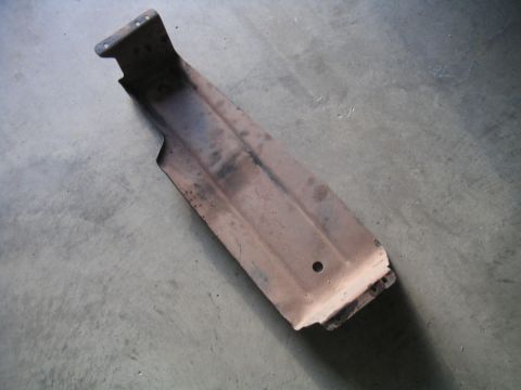 1994 Ford Bronco - This is a metal bracket, likely a vehicle part, shown on a concrete surface.