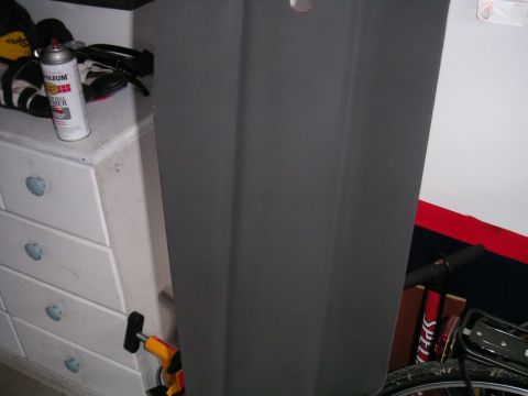 1994 Ford Bronco - A gray car door is shown leaning against a dresser, with a can of spray primer on the dresser.
