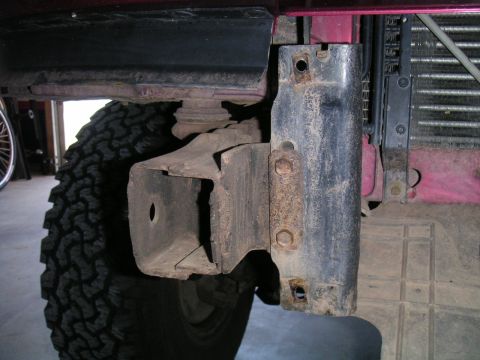 1994 Ford Bronco - This photo shows a close-up view of the front driver's side frame and tire of a vehicle, with a portion of the radiator visible.