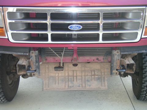 1994 Ford Bronco - Front view of a red 1994 Ford Bronco, highlighting its grille and tow hooks.