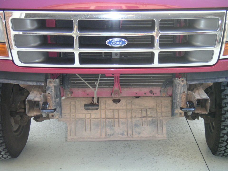 Red 1994 Ford Bronco front grille with chrome accents and tow hooks