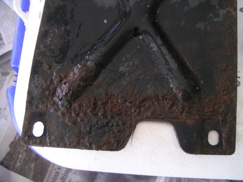 1994 Ford Bronco - This heavily rusted metal bracket shows significant corrosion and wear.