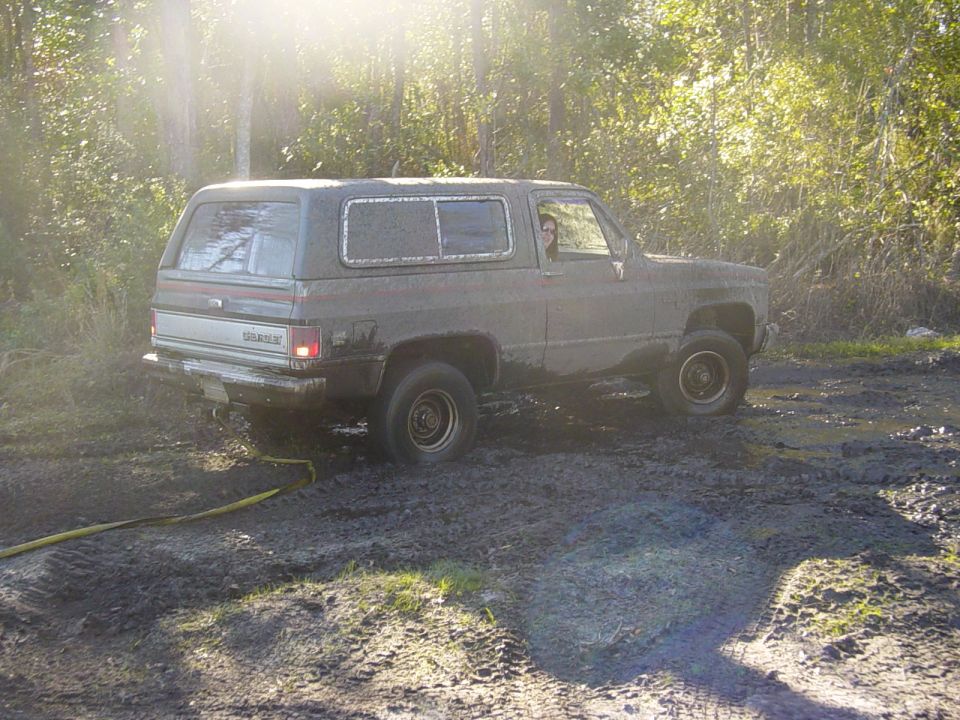 1980s Chevrolet K5 Blazer stuck in mud with trees in background