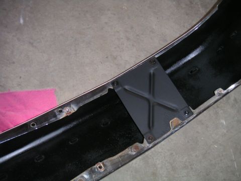 1994 Ford Bronco - This is a close-up view of the inside of a vehicle's bumper, showing a metal reinforcement bracket.