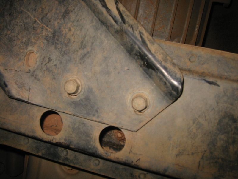 Transfer case skid from underneath passenger side showing mount to crossmember.