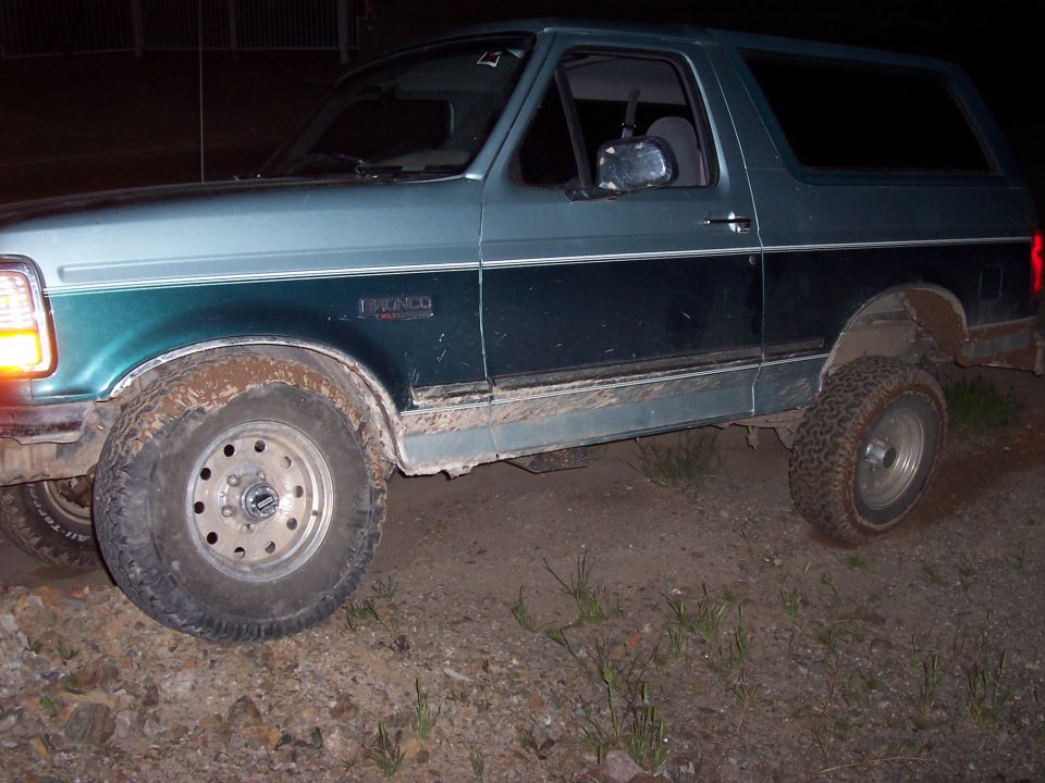 Ford Bronco, looks like early 90s model, side view, muddy