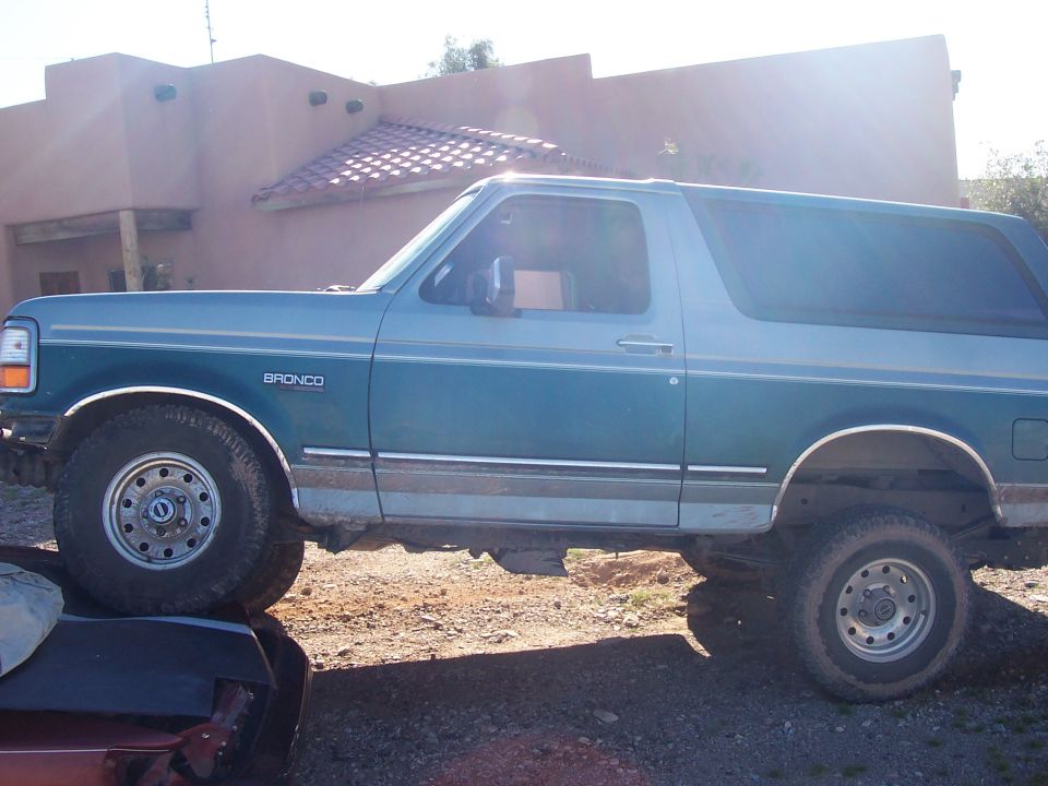 1996 Ford Bronco side view, teal and gray two-tone paint, lifted