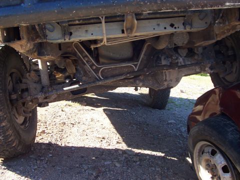 1996 Ford Bronco - The underside of a vehicle is shown, with another vehicle partially visible to the right.