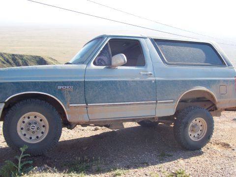 1996 Ford Bronco - This 1996 Ford Bronco is seen from the side, its distinctive two-tone paint scheme and prominent "BRONCO" badging.
