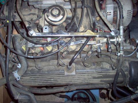 1994 Ford Crown Victoria - Close-up view of an engine bay, showing fuel rails, wiring, and other engine components.