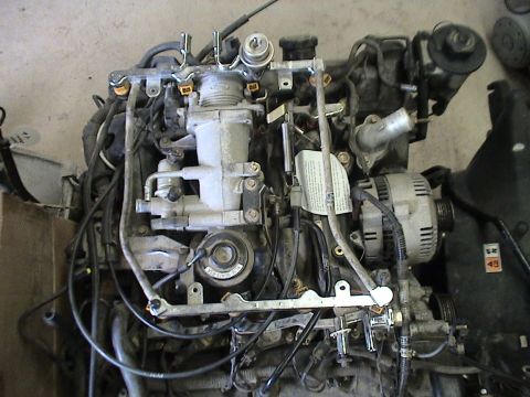 1994 Ford Crown Victoria - Engine assembly with visible components and wiring. A label is attached to the engine block.