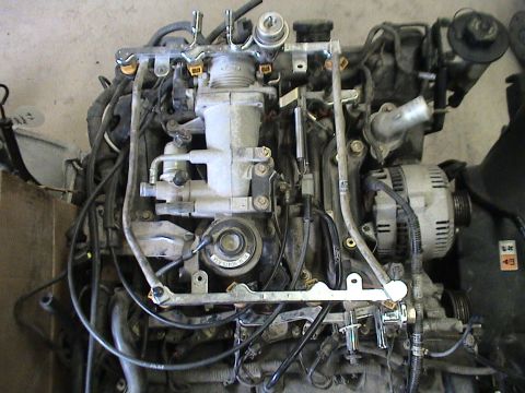 1994 Ford Crown Victoria - This is a close-up view of a vehicle engine assembly, showing many components and wiring.