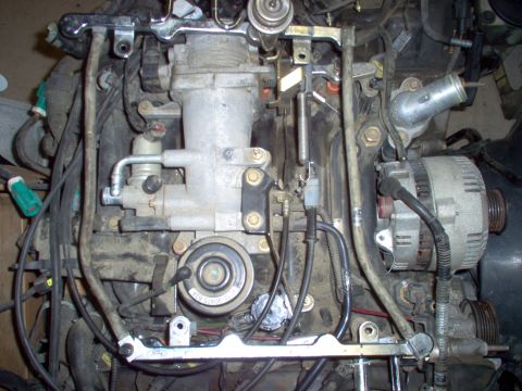 1994 Ford Crown Victoria - Close-up view of an engine assembly, showing components like the alternator and throttle body.