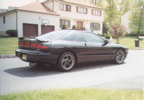 1997 Ford Probe - A black coupe with a distinctive rear spoiler and alloy wheels is seen from a three-quarter front angle.
