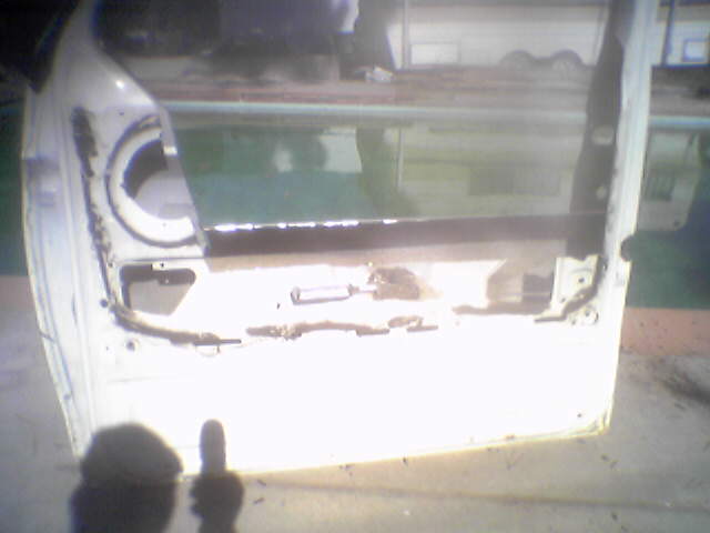 this is a day time shot for RAFFA.  shows where I cut the back side.   front is cut and folded over so it will provide support and filler for the new top of door. 
shadow is not me flipping you off ..its my camera