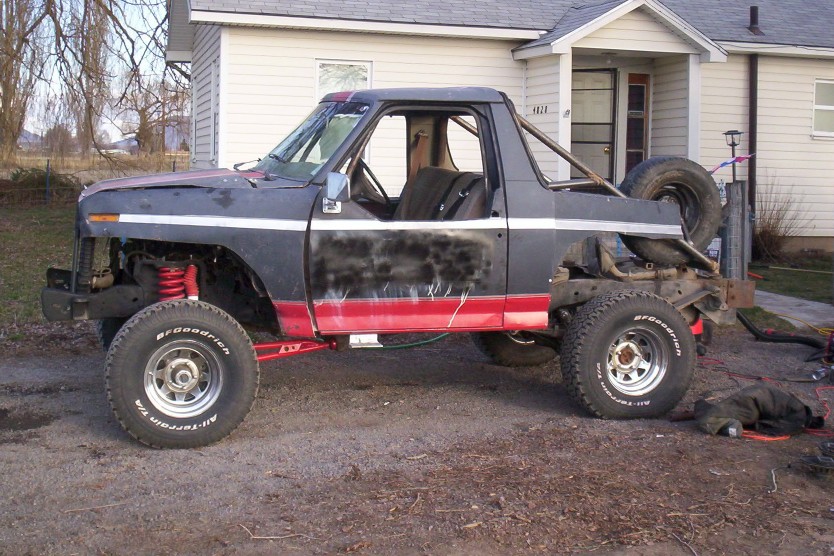 Black and red Ford Bronco stripped to a roll cage on BFGoodrich all-terrain tires