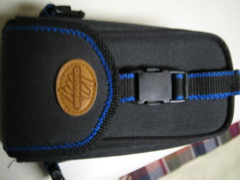 1996 Ford Bronco - A black textile pouch with blue trim and a leather logo is shown.