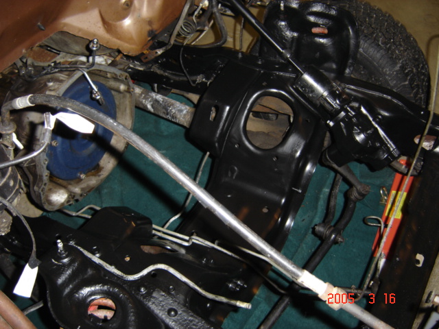 Empty engine bay from above with freshly painted black inner fenders and shock towers