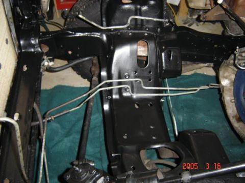 1990 Ford Bronco - Passenger-side engine bay repainted gloss black, with the shock tower, inner fender and frame rail freshly coated and new brake hard lines…