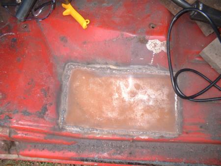 1978 Ford Bronco - A section of a vehicle's floor pan has been repaired with a welded patch.