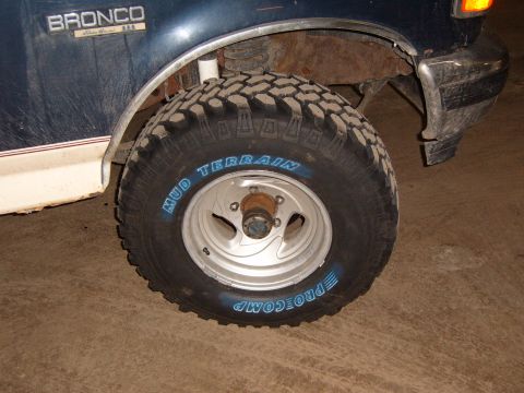 1993 Ford Bronco - The front driver's side tire of a 1993 Ford Bronco is visible, with "MUD TERRAIN" and "PROCOMP" written on it.