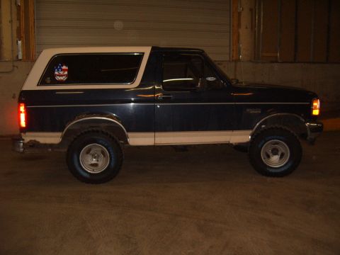 1993 Ford Bronco - This 1993 Ford Bronco is seen from the side, a two-tone paint scheme with a white roof and blue lower body.