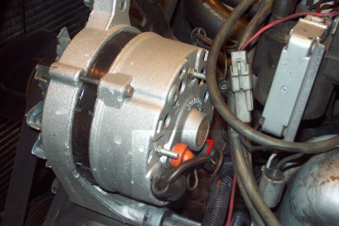 1985 Ford Crown Victoria LTD - This is a close-up view of a vehicle's alternator, a key component in the electrical system.