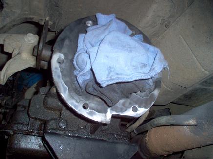 1988 Ford Bronco - A close-up view of a vehicle's transfer case component, covered with a blue rag.