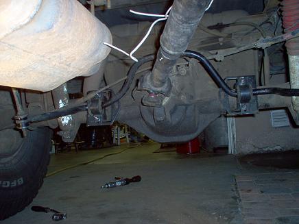 1988 Ford Bronco - Close-up of the rear axle and suspension of a 1988 Ford Bronco, showing leaf spring and bushing work.