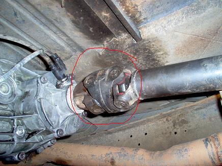 1988 Ford Bronco - Close-up view of a driveshaft U-joint, highlighted with a red circle.