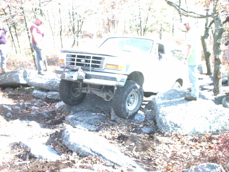 Ford Bronco navigating rocks on an off-road trail