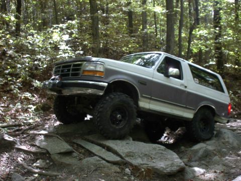 1995 Ford Bronco - This 1995 Ford Bronco is navigating a rocky path in a forest.
