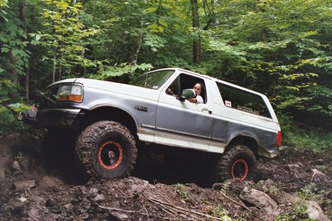 1995 Ford Bronco - This 1995 Ford Bronco navigates a challenging muddy off-road trail.