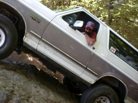1995 Ford Bronco - This Ford Bronco is shown navigating a challenging off-road trail with steep rocks.