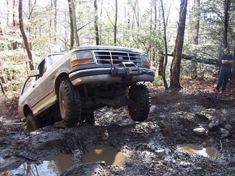 1995 Ford Bronco - This 1995 Ford Bronco tackles a challenging muddy terrain, its off-road capabilities.