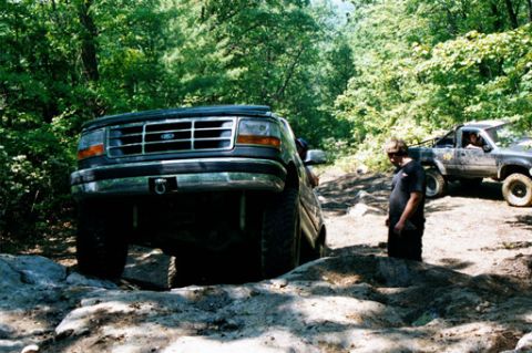 1995 Ford Bronco - This Ford F-Series truck navigates a rocky trail with another vehicle in the background.