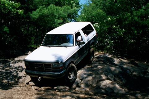1995 Ford Bronco - This 1995 Ford Bronco navigates a rocky path through a wooded area.