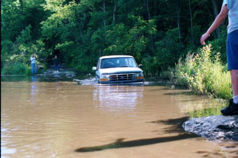 1995 Ford Bronco - A 1995 Ford Bronco navigates through a water crossing.