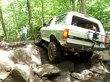 1995 Ford Bronco - This white Ford Bronco navigates a challenging rocky off-road trail.