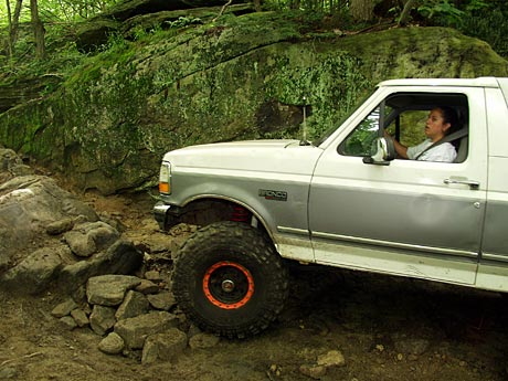 1995 Ford Bronco - A 1995 Ford Bronco navigates a rocky trail, demonstrating its off-road capabilities.