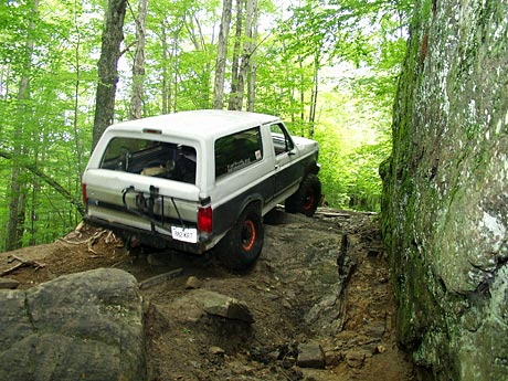 1995 Ford Bronco - This Ford Bronco navigates a challenging off-road course with steep inclines and large rocks.