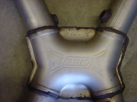 1989 Ford Bronco - Close-up of an exhaust y-pipe the BBR logo embossed on its surface.