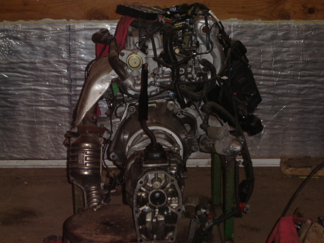 Engine and transmission assembly on a stand, viewed from the front