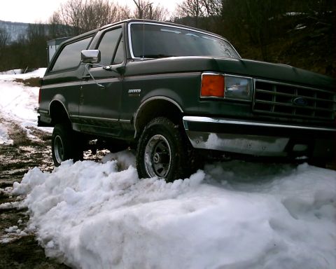 1988 Ford Bronco - This 1988 Ford Bronco navigates through a snowy landscape, its robust build.