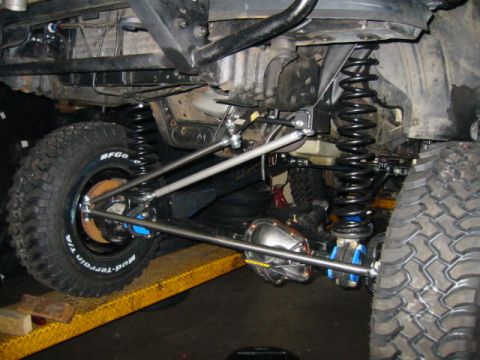 1992 Ford Bronco - Close-up view of a heavily modified off-road vehicle's rear axle and suspension system.